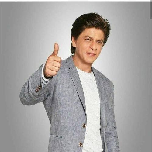 Shahrukh khan in grey cot with white t-shirt and professional hairstyle
