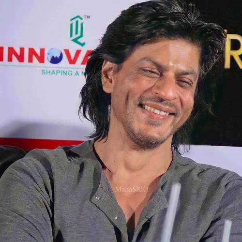 Shahrukh khan in grey shirt and messy medium hairstyle